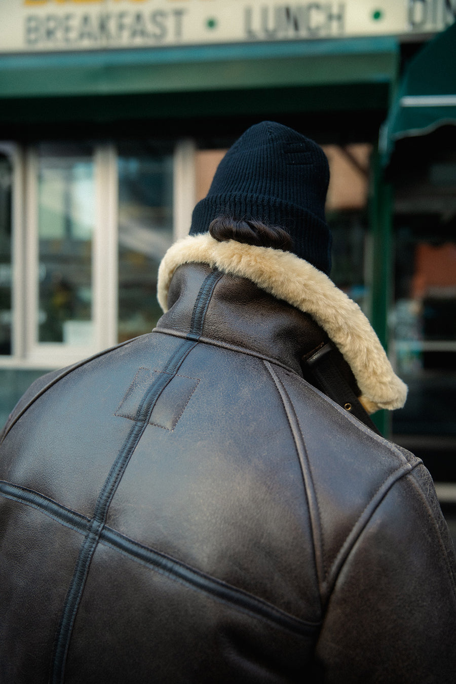 A back shot of the jacket with the collar standing up.