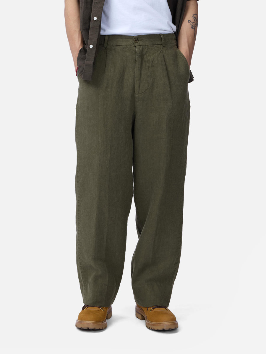 Person wearing olive green pants on a white background