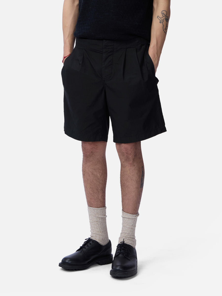 Person wearing black shorts on a white background