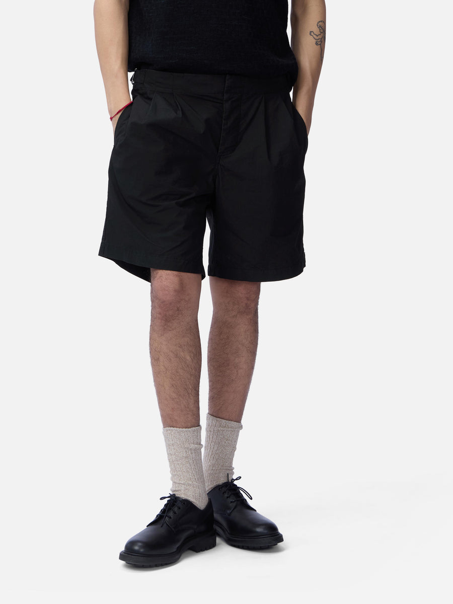 Person wearing black shorts on a white background