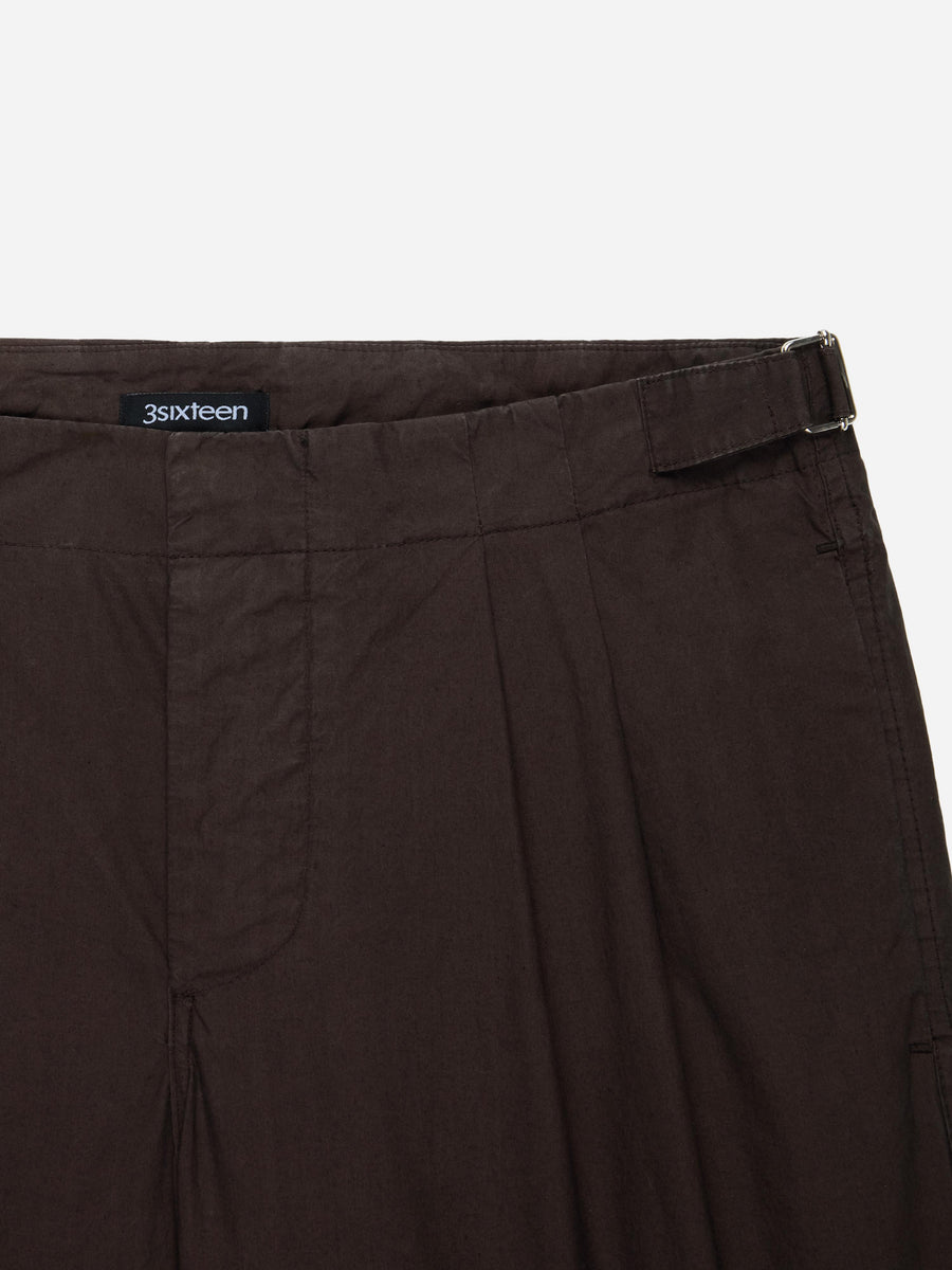 Brown pants with a visible brand label on a white background
