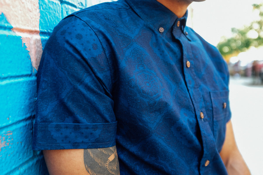 An up close shot of an indigo bandana-print short sleeve shirt.